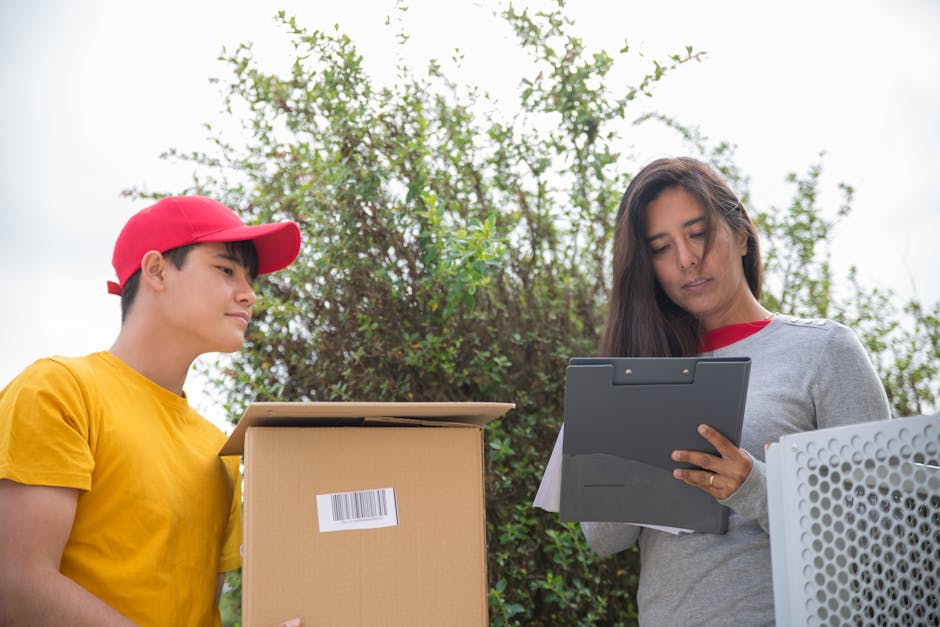 Courier delivering a package while a woman signs a form outdoors.